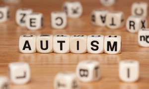 The word AUTISM spelled out in letter cubes.
